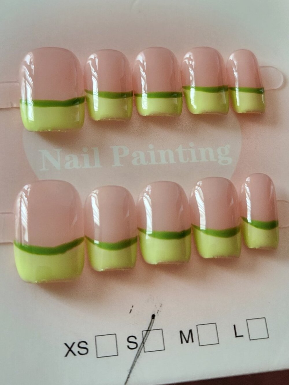 Short green french-tip press-on nails. Size small.